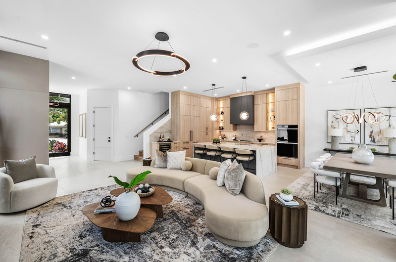 Curved sofa, kitchen, and dining area in the open-plan living space